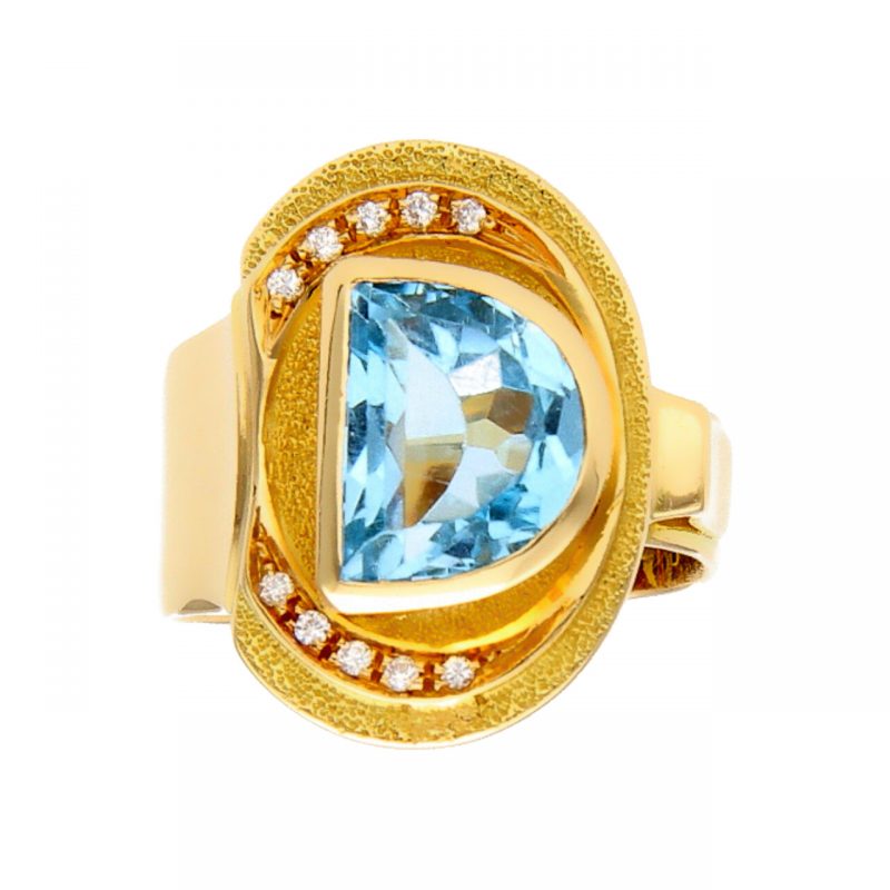 Yellow gold ring with blue topaz and diamonds